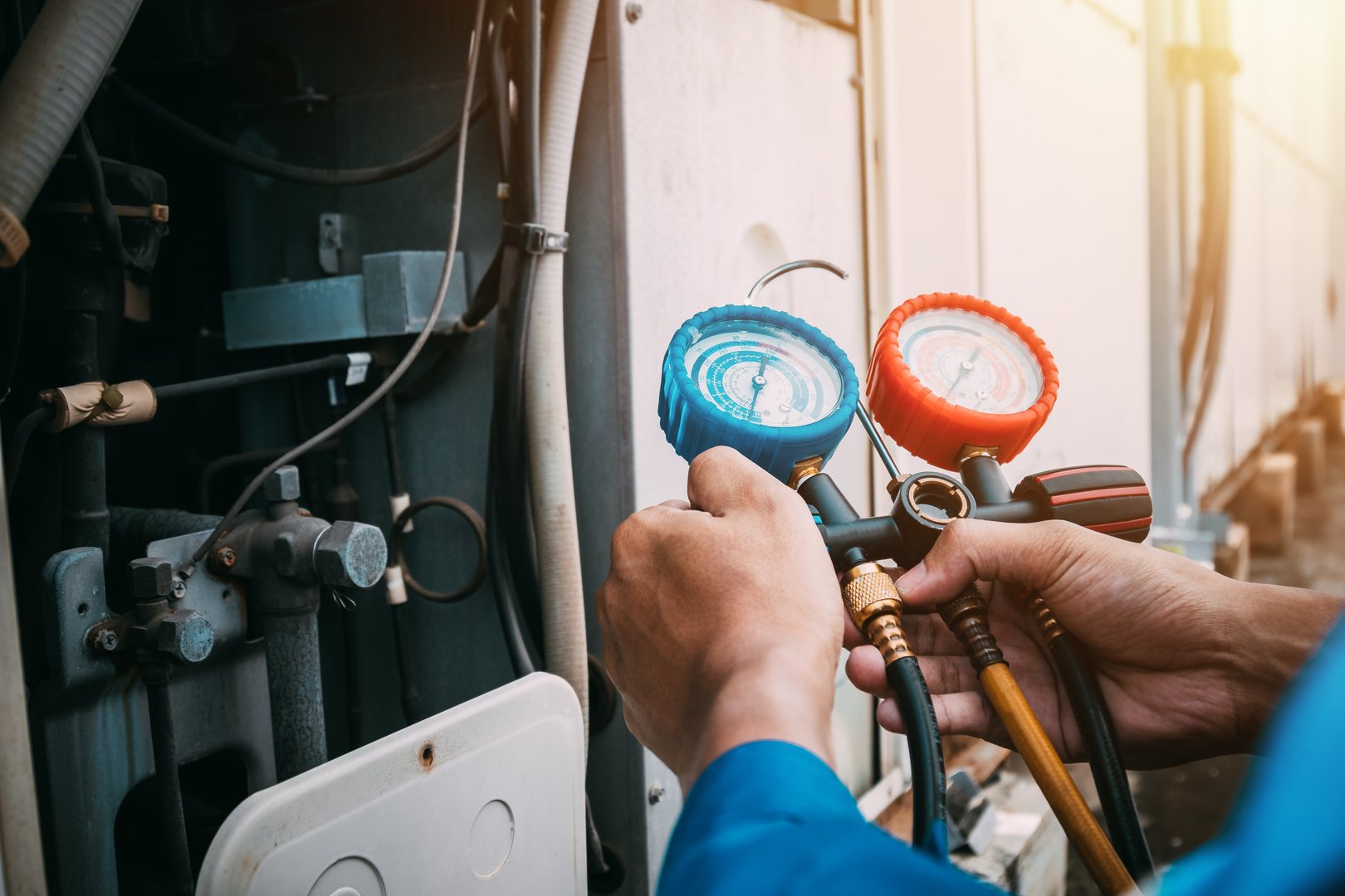 Technician is checking air conditioner refrigerant leak.